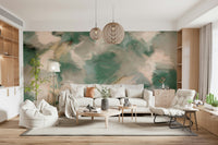 Ethereal Brushstrokes wallpaper mural of soft green strokes behind a cream sofa with round wood table and rattan pendants