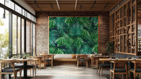 Green Leaves wallpaper mural styled as a feature wall behind a dining table and chairs in green tones