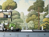 Green Natural Woodcut Forest wallpaper of green woodland trees above blue-gray cabinets and a white kitchen sink