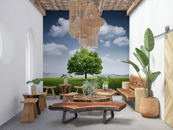 Fields of Green wallpaper mural of a lone tree and grassy field on a covered patio with live-edge wood tables and stools