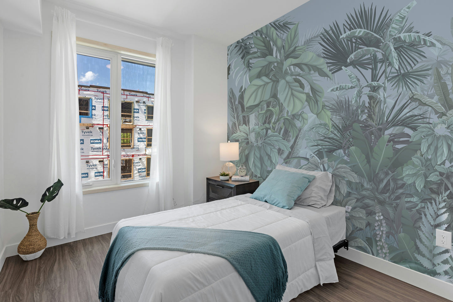 Green Tropical Leaf Forest wallpaper mural styled as a feature wall behind a dining table and chairs