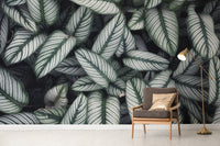 Green White Leaves wallpaper mural as a bedroom feature wall behind the headboard in green tones