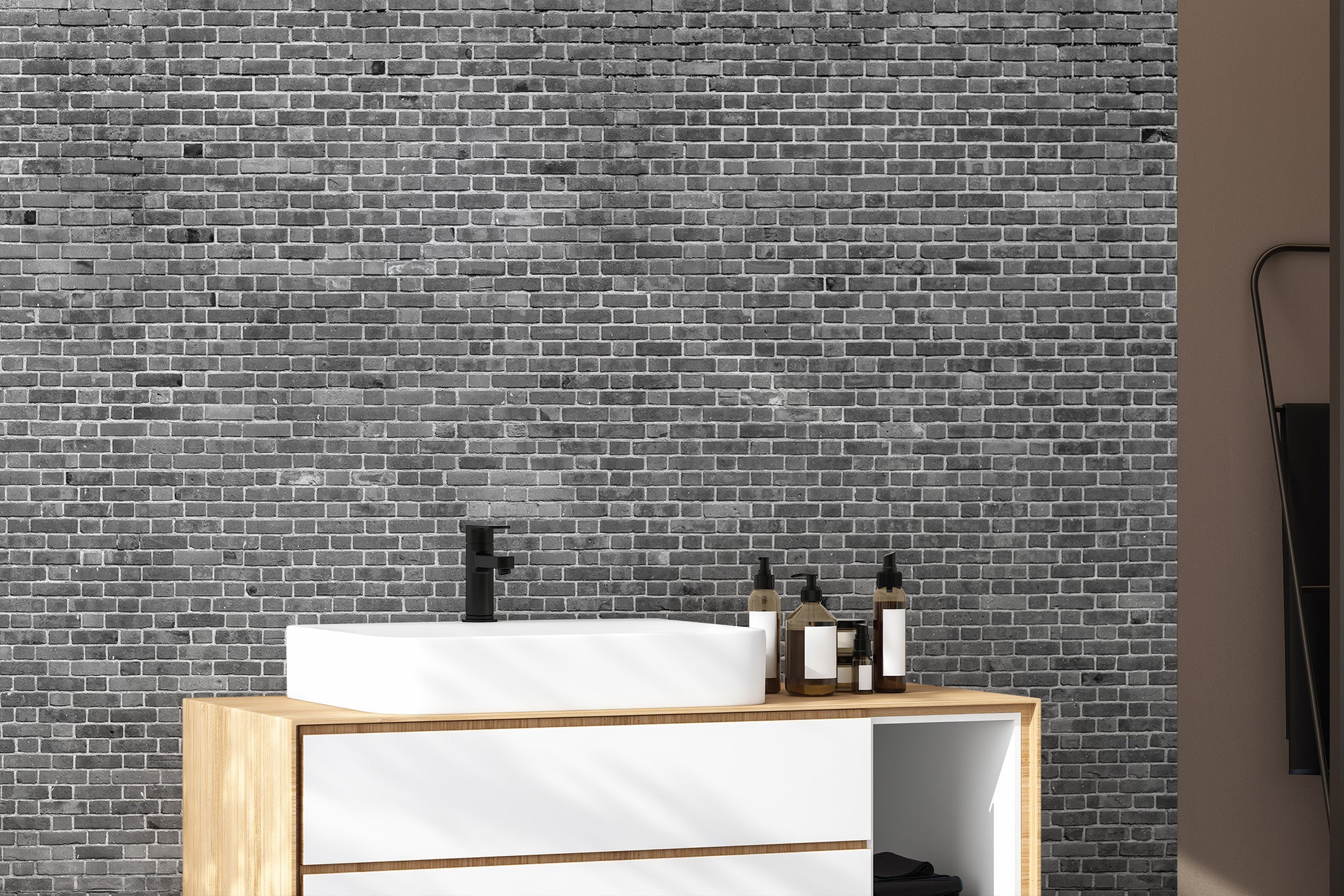 Grey brick wallpaper mural in a modern  bathroom with natural light.