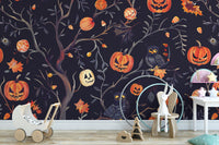 Removable self adhesive Halloween pumpkins owls wall mural in a nursery with a wooden walker toy and a minimalist rug.