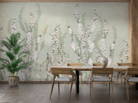 Hanging Flower on Green wallpaper mural of pink florals on sage green behind a wood dining table and potted palm