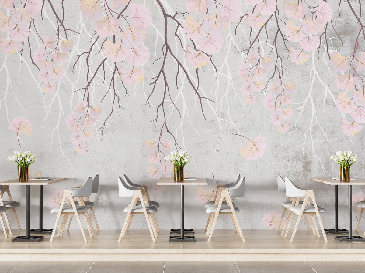 Hanging pink flowers wallpaper mural with pink blooms on grey behind cafe-style wood tables and grey chairs