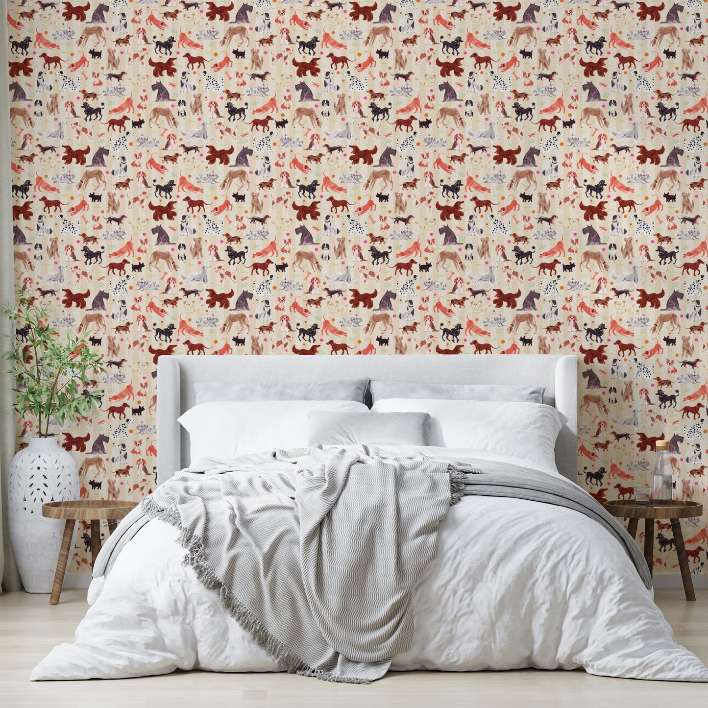 Happy Hounds Dog Doodles wallpaper of red and purple dogs behind a white headboard bed with a grey throw