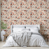 Happy Hounds Dog Doodles wallpaper of red and purple dogs behind a white headboard bed with a grey throw