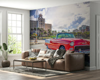 The mural shows a vibrant street with colonial buildings.

