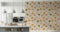 Playful heart shapes in mustard, olive, blush, and beige forming a sweet pattern on this wallpaper.
