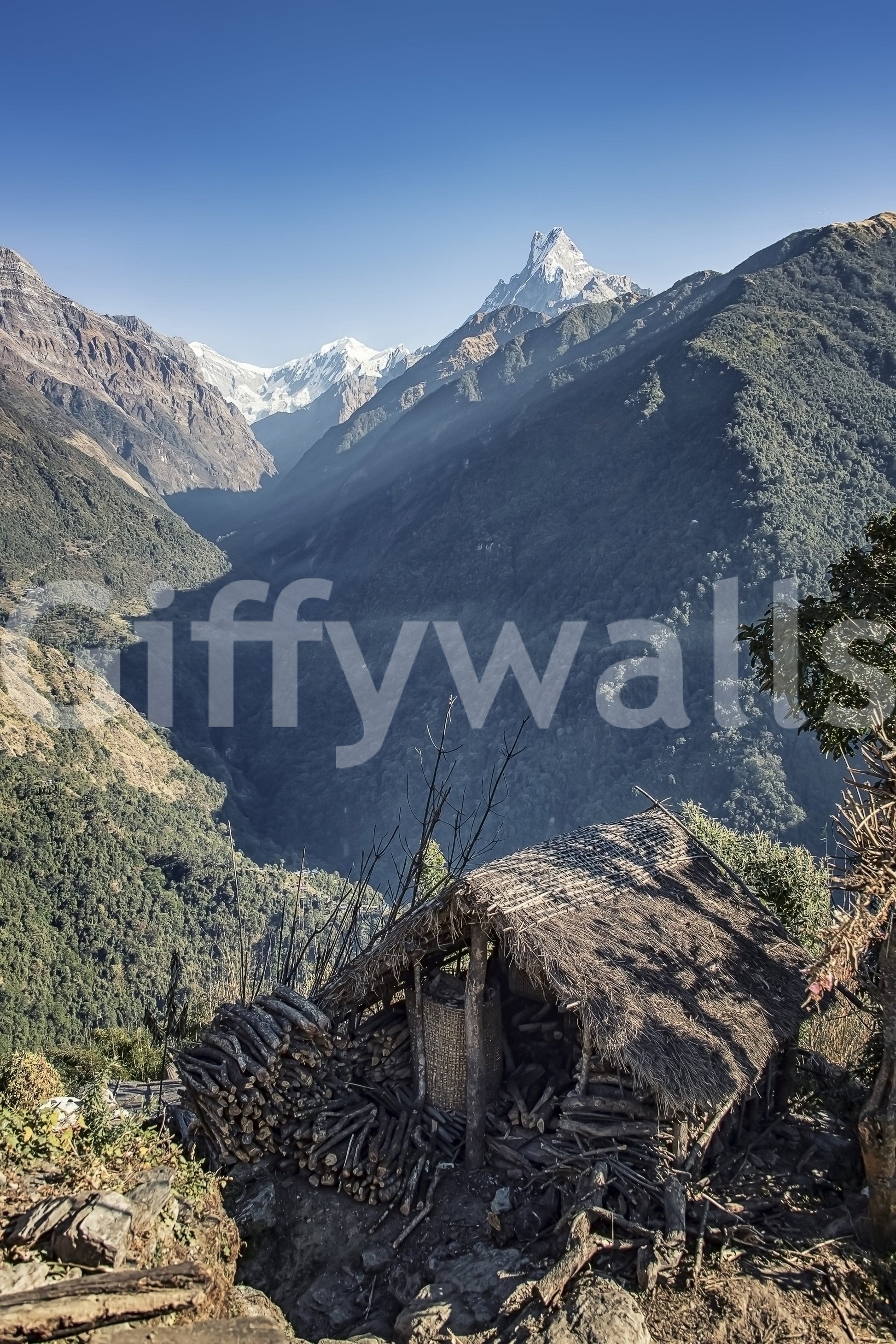 Travel-inspired wall mural featuring a remote hut and breathtaking mountainous terrain.