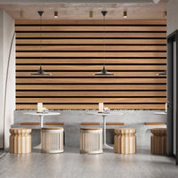Horizontal Stripes Wood Various Design wallpaper in warm wood tones behind white tables and rattan stools in a cafe lounge