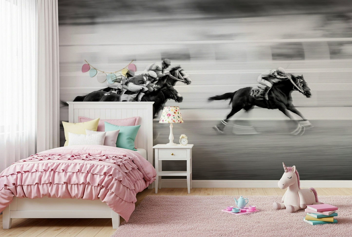 The Thrill of the Race wallpaper mural of black-and-white galloping racehorses in a girl's pink bedroom with unicorn toy