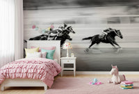 The Thrill of the Race wallpaper mural of black-and-white galloping racehorses in a girl's pink bedroom with unicorn toy
