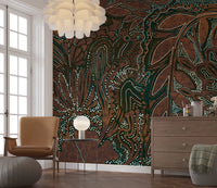 Indigenous Forest wall mural behind a tan leather chair and wood dresser in a living room
