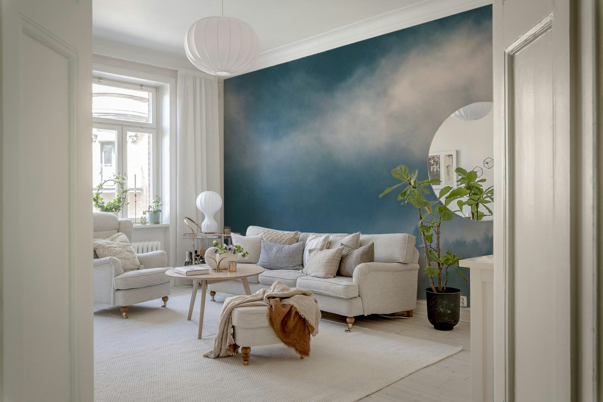 Misty forest wall mural in indigo, featuring looming pine shapes.