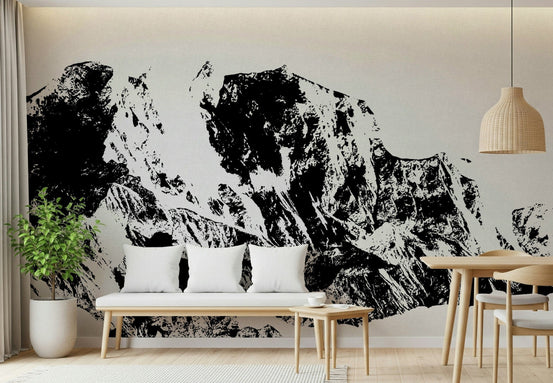 Ink Mountain Ascent wallpaper mural in black and white behind a wood bench with white pillows in a living room