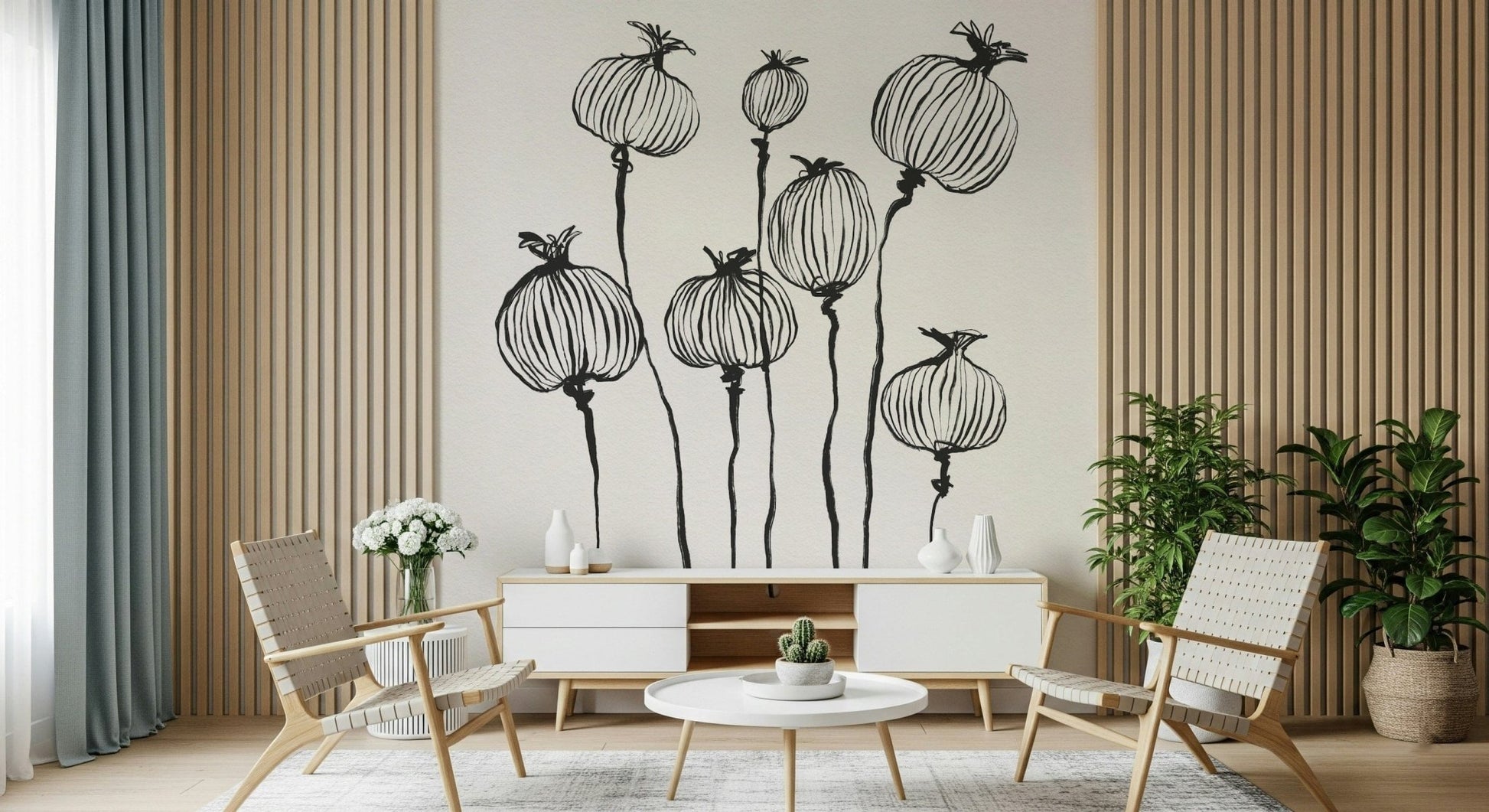 Ink Poppy Pods wallpaper mural with black seed pods behind a white credenza and woven lounge chairs