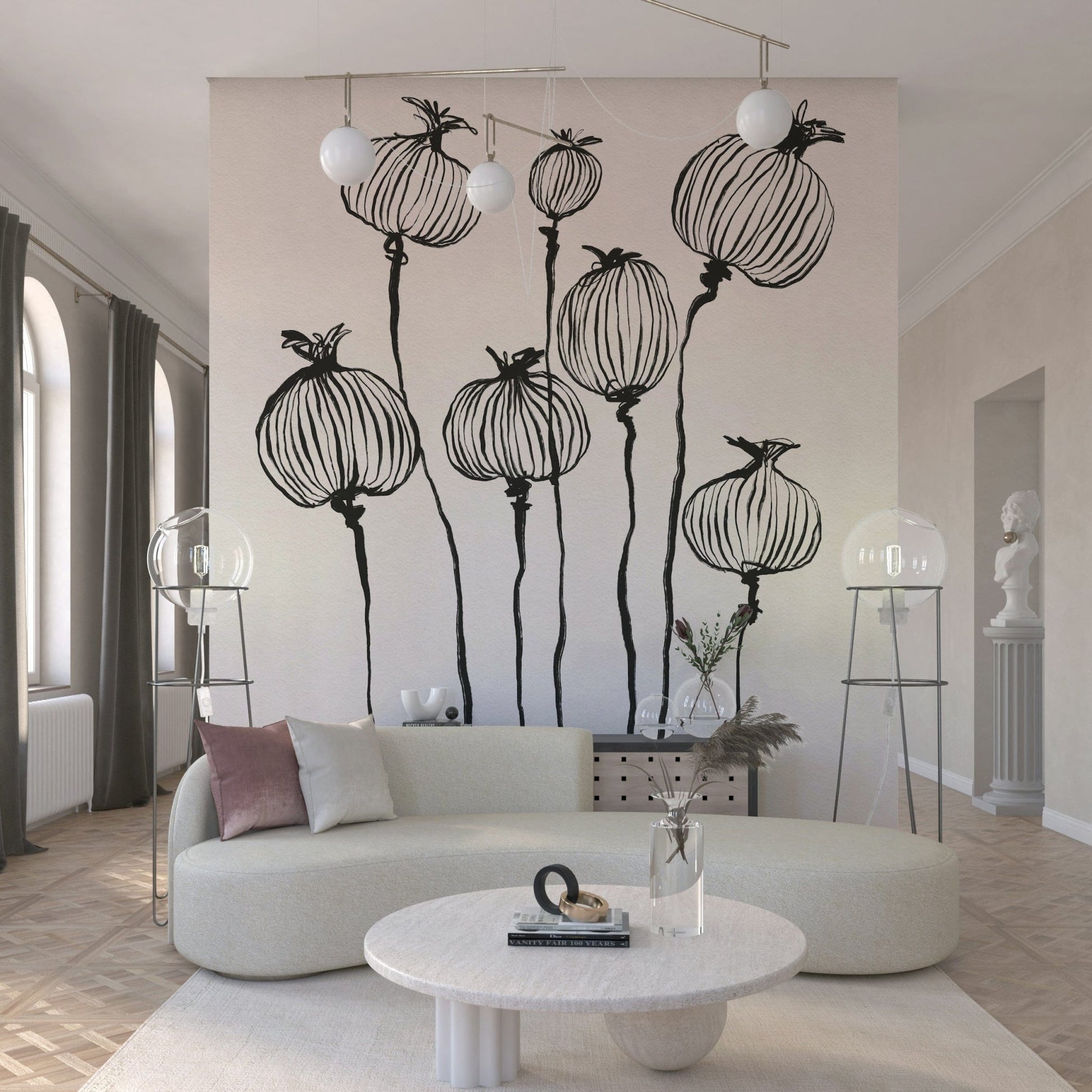 Ink Poppy Pods wallpaper mural of black seed pods behind a cream curved sofa with two globe floor lamps