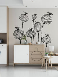 Ink Poppy Pods wallpaper mural of sketched poppy pods above a wood and white sideboard in an entryway