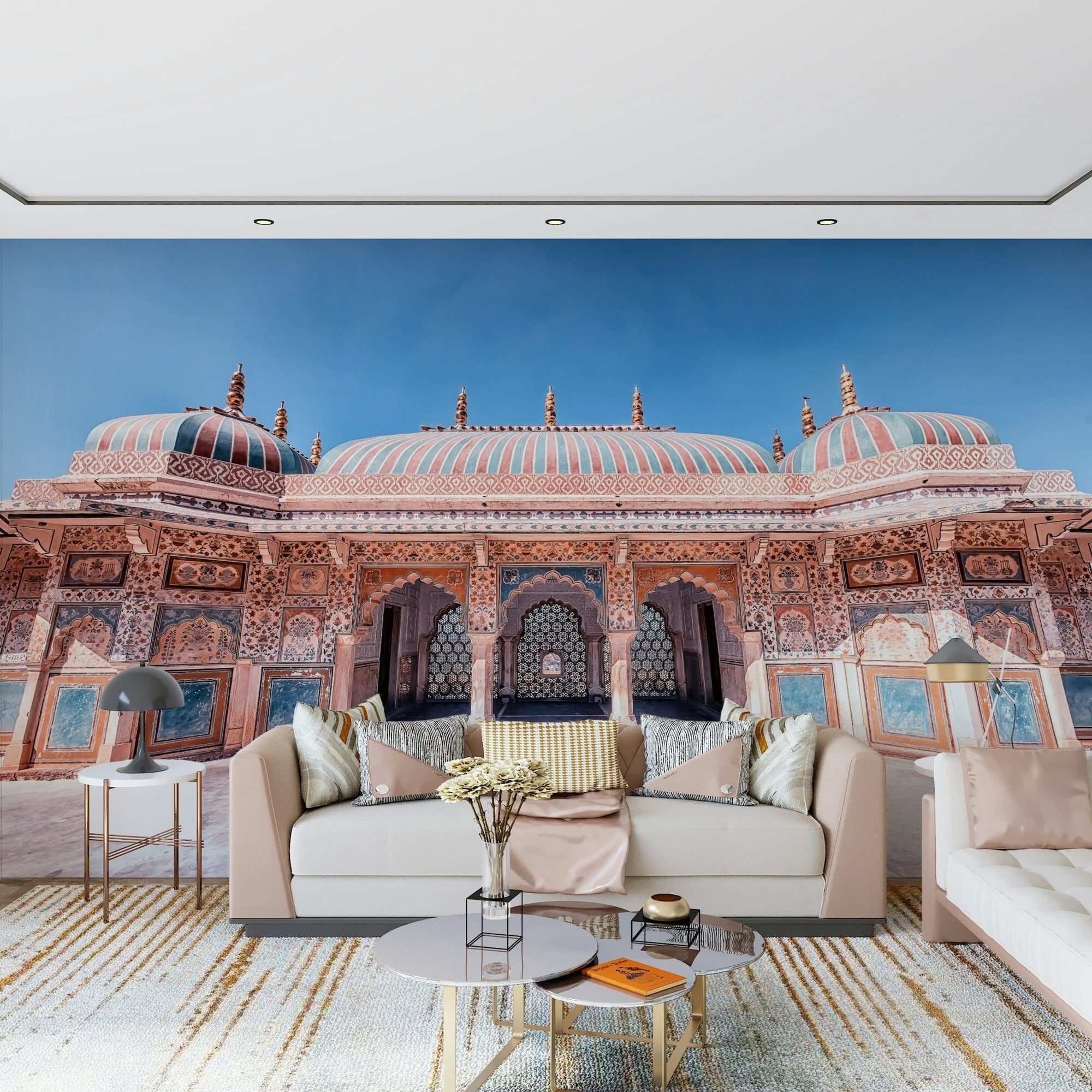 Jaipur Jewel wallpaper mural of an ornate pink Jaipur palace behind a blush sofa with gold-framed marble tables