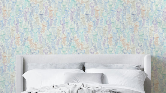 Jellyfish Doodles wallpaper in pastel tones behind a gray upholstered bed with white and gray bedding