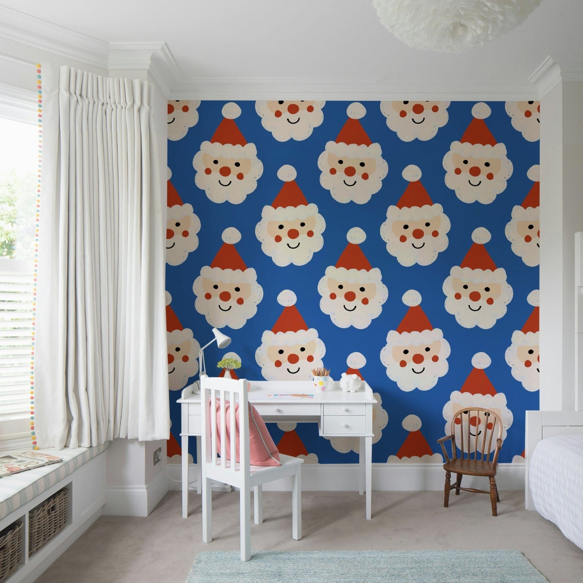 A cheerful Santa-themed wallpaper featuring repeating smiling Santa faces on a bright blue background.
