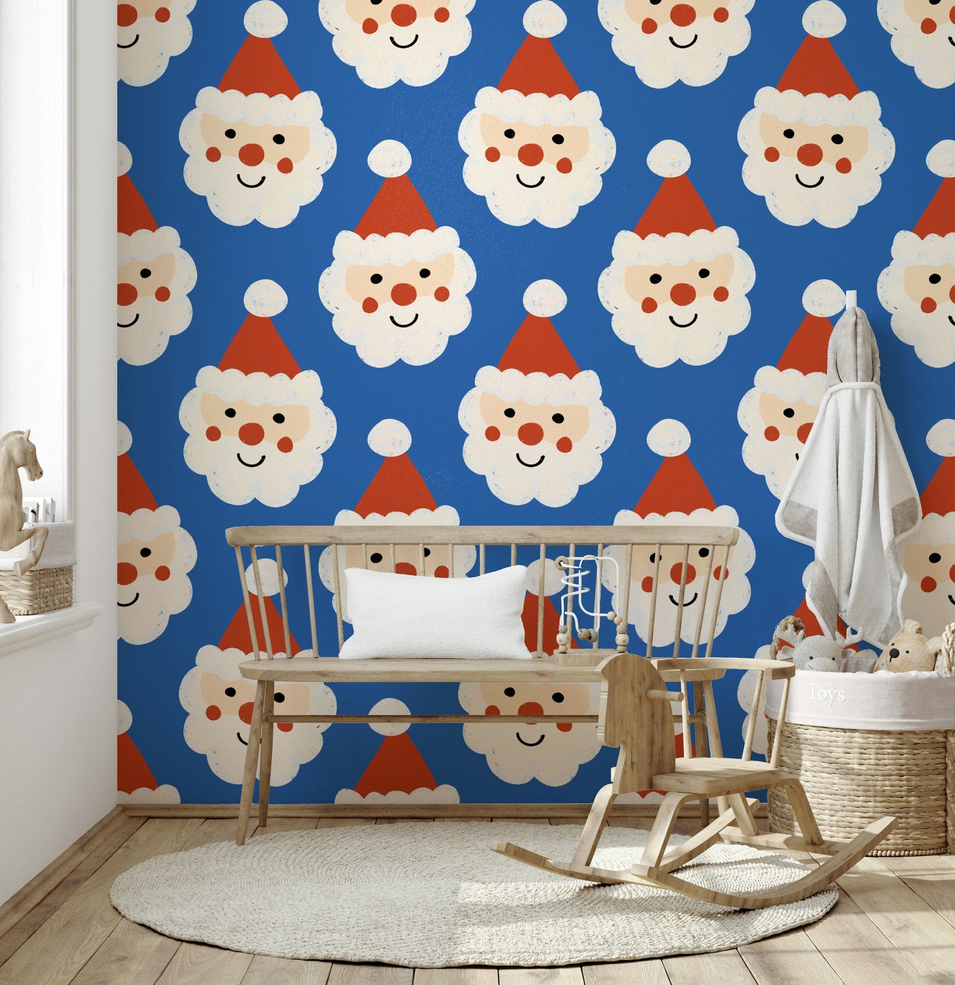 Blue holiday wallpaper covered in happy Santa faces with rosy cheeks and fluffy beards.