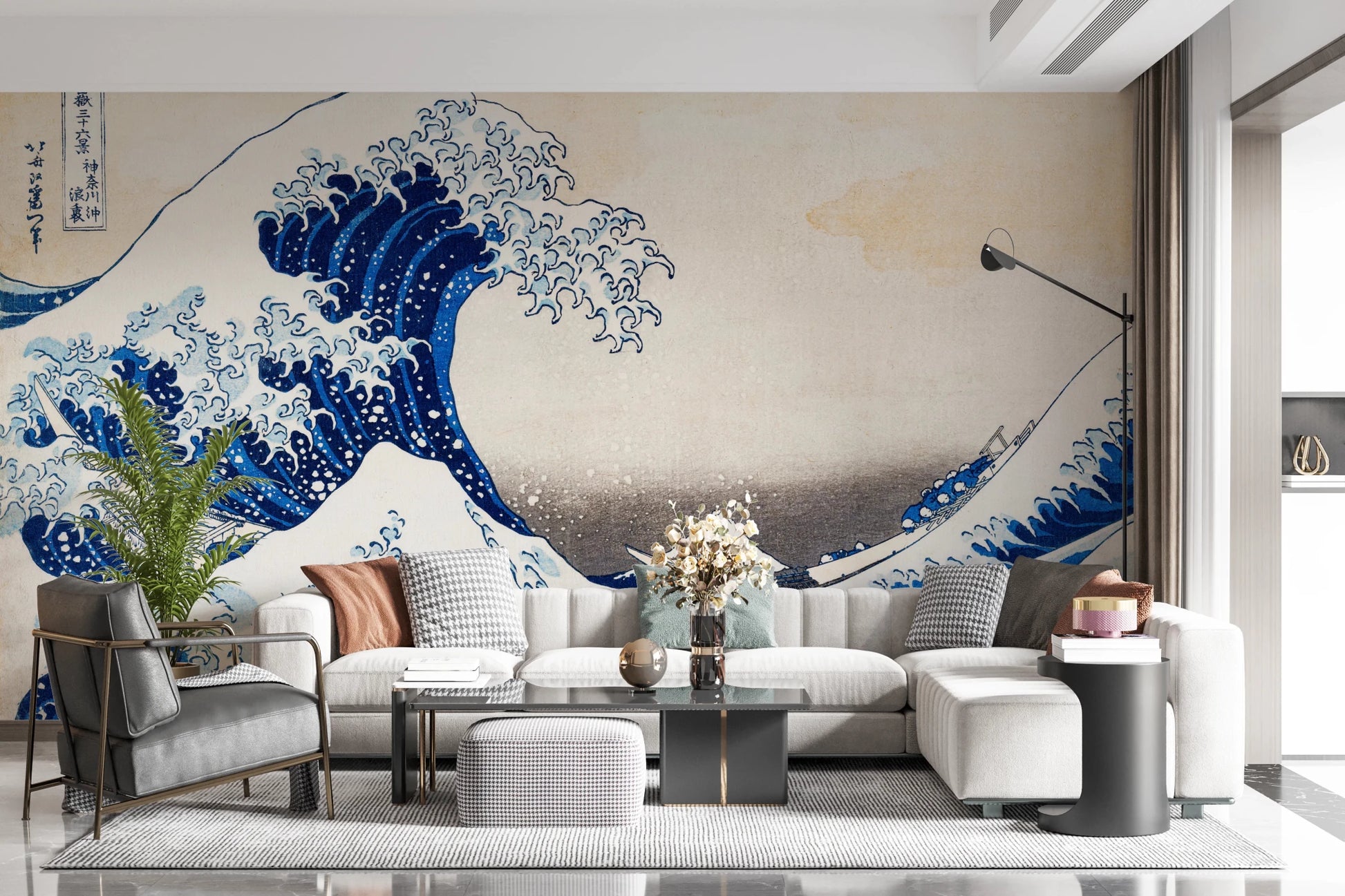 Katsushika Hokusai's The Great Wave off Kanagawa wallpaper mural of the blue wave behind a white sectional sofa and houndstooth ottoman