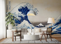 Katsushika Hokusai's The Great Wave off Kanagawa wallpaper mural of the blue wave behind a white sofa, cane chair and terrazzo table