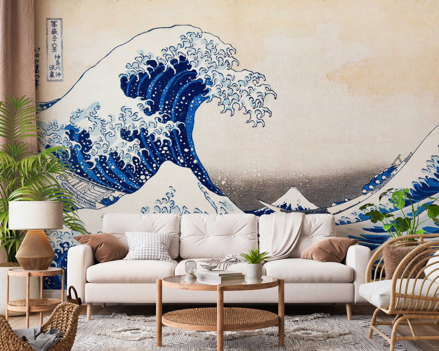 Katsushika Hokusai's The Great Wave off Kanagawa wallpaper mural of the blue wave behind a cream sofa and rattan chair in a living room