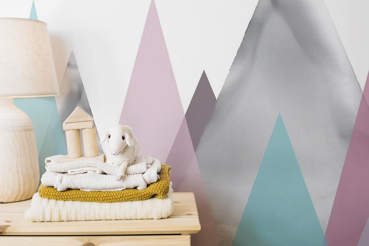 Colorful mountain wall mural featuring dusty blue and pale yellow shades.