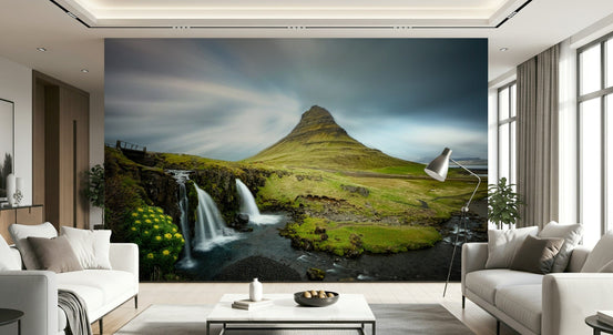 Kirkjufell Mountain Serenity wallpaper mural of the green peak and waterfalls behind two cream sofas in a living room