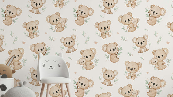Koala Cuddles wallpaper in cream behind a white cat-ear chair with plush toys in a child's room