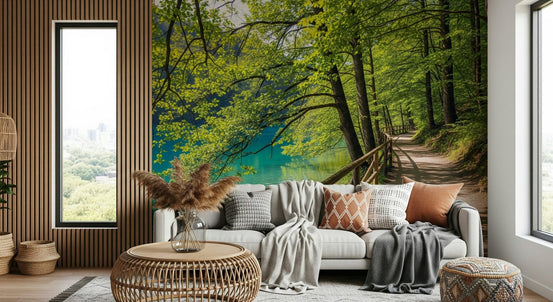 Lakeside Serenity wallpaper mural of a turquoise lake and forest path behind a white sofa in a living room