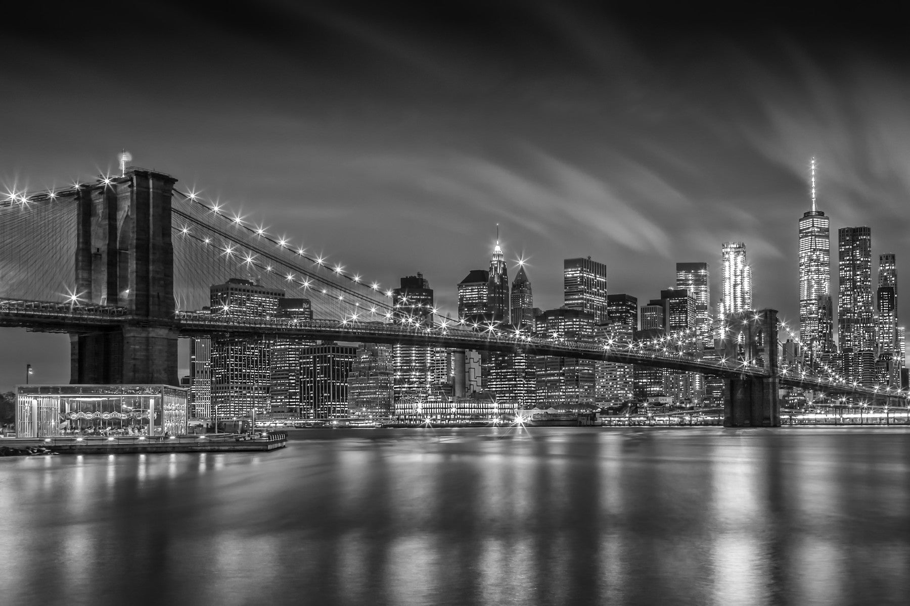 Brooklyn Bridge at night in monochrome with illuminated cables

