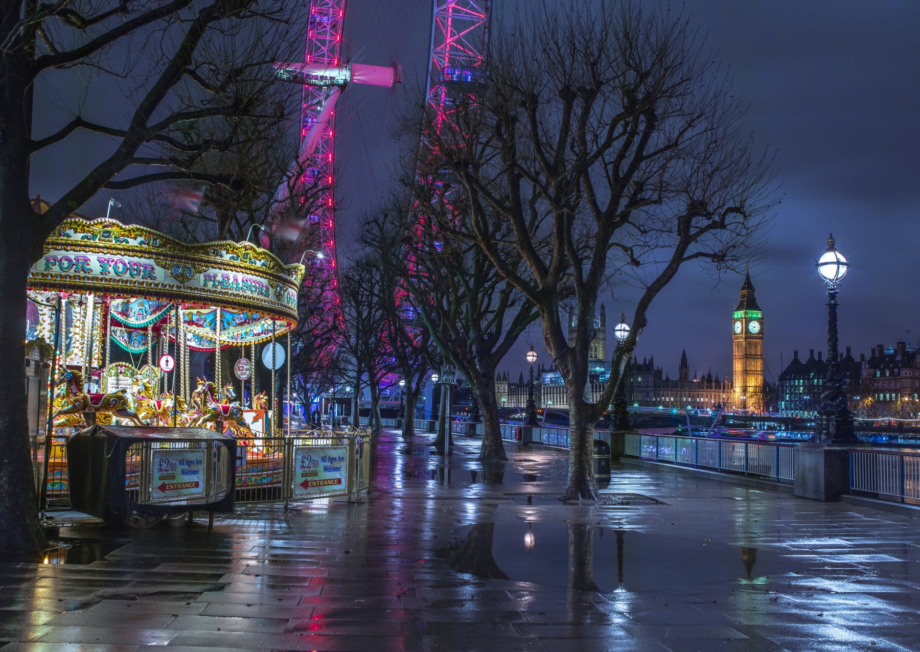 London Evening wallpaper mural of the illuminated London Eye, Big Ben and a lit carousel behind a desk in a home office