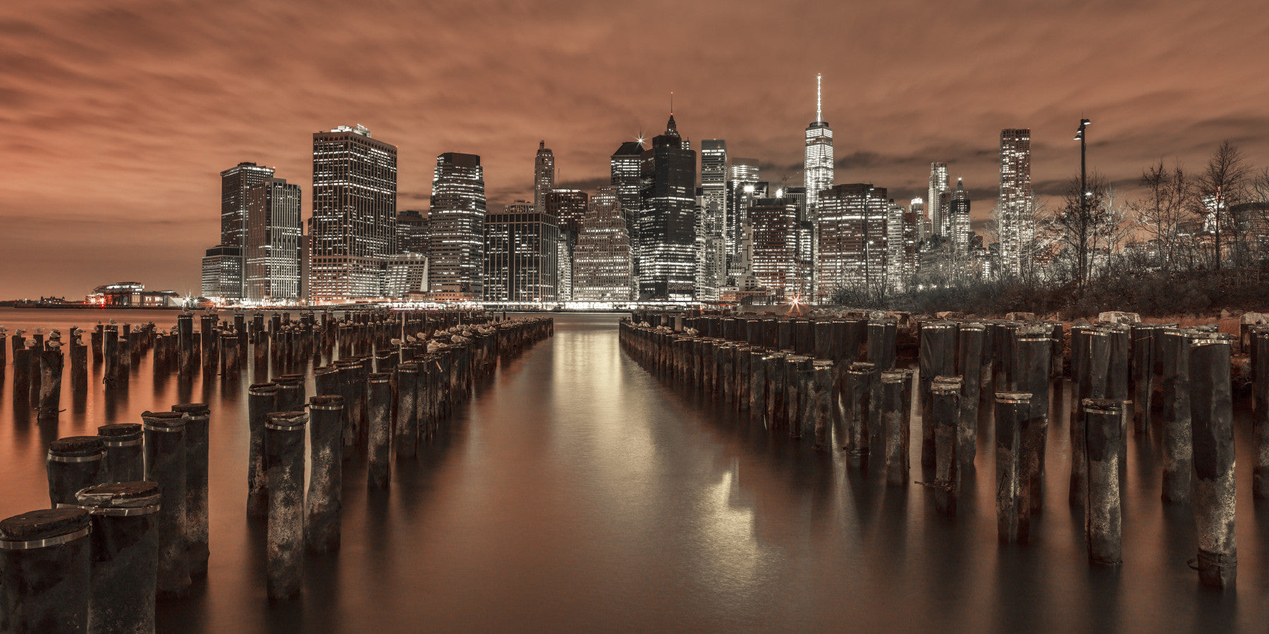 A high-resolution photo-realistic wall mural of the Manhattan skyline at dusk.


