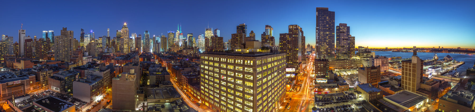 The image shows a full wall with glowing buildings and city lights.

