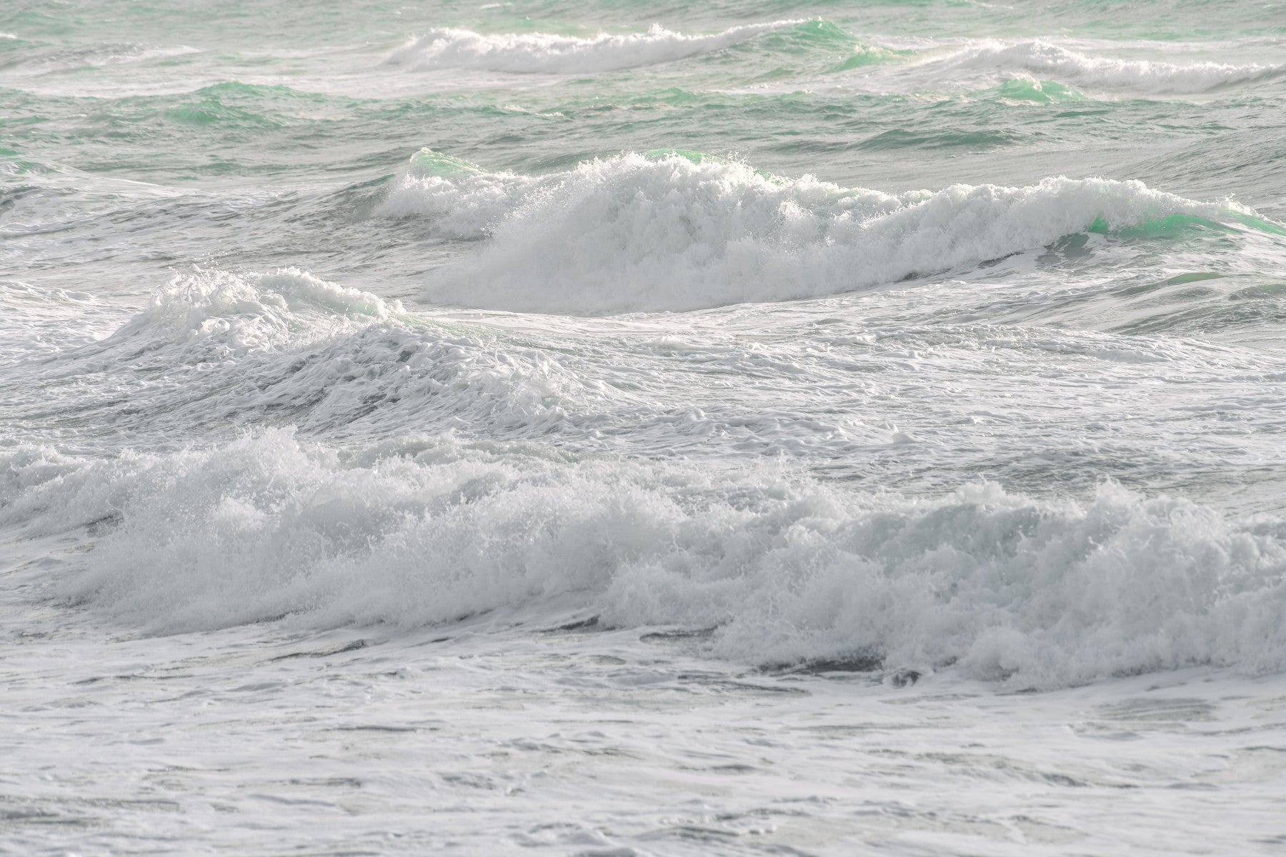 A beautiful photo of churning, frothy ocean waves.

