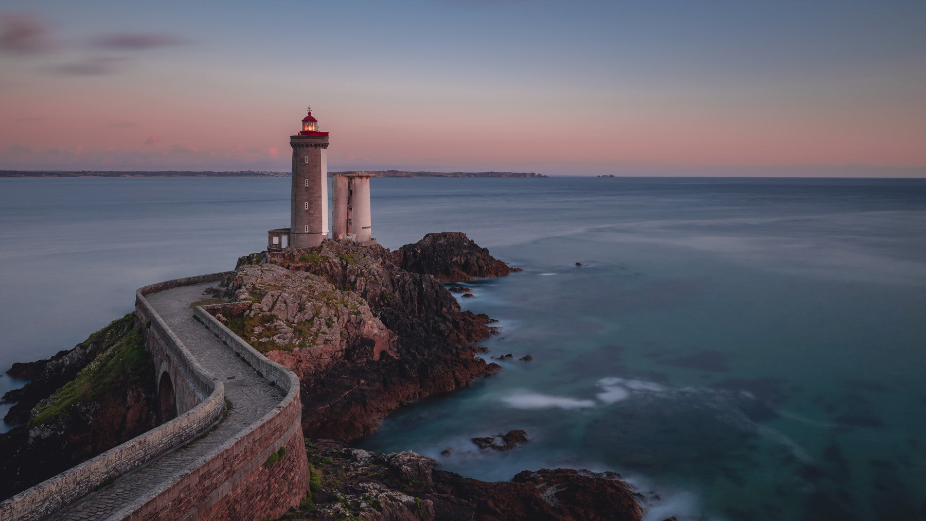 Wall mural with a serene lighthouse scene and calm coastal waters for relaxing interiors.