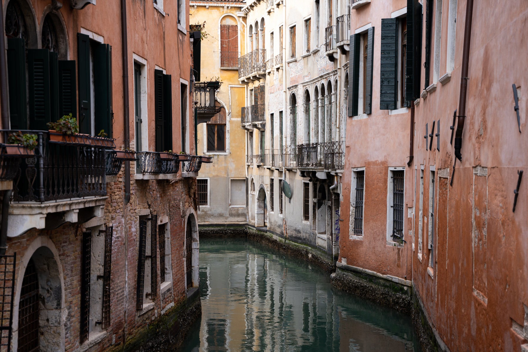 Venetian Canal Vista Wall Mural featuring picturesque canals and colorful buildings in Venice.