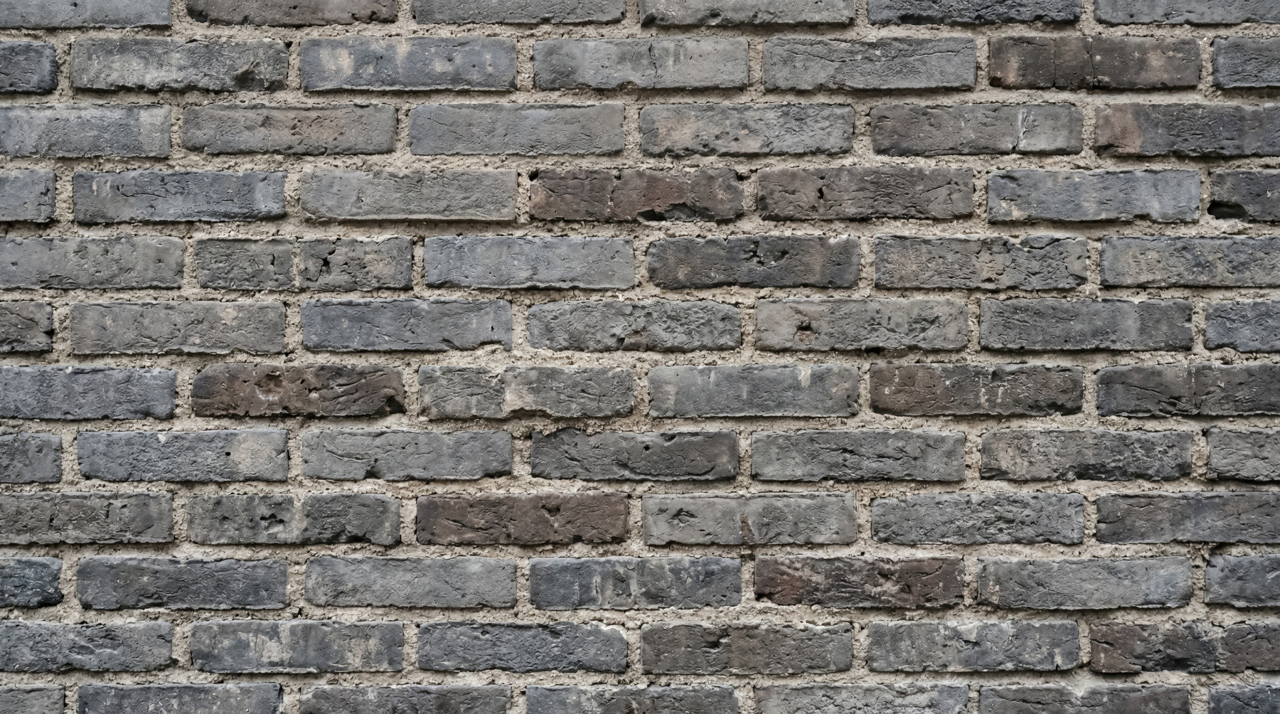 Living room with Urban Gray brickwork wall mural in a rough textured finish