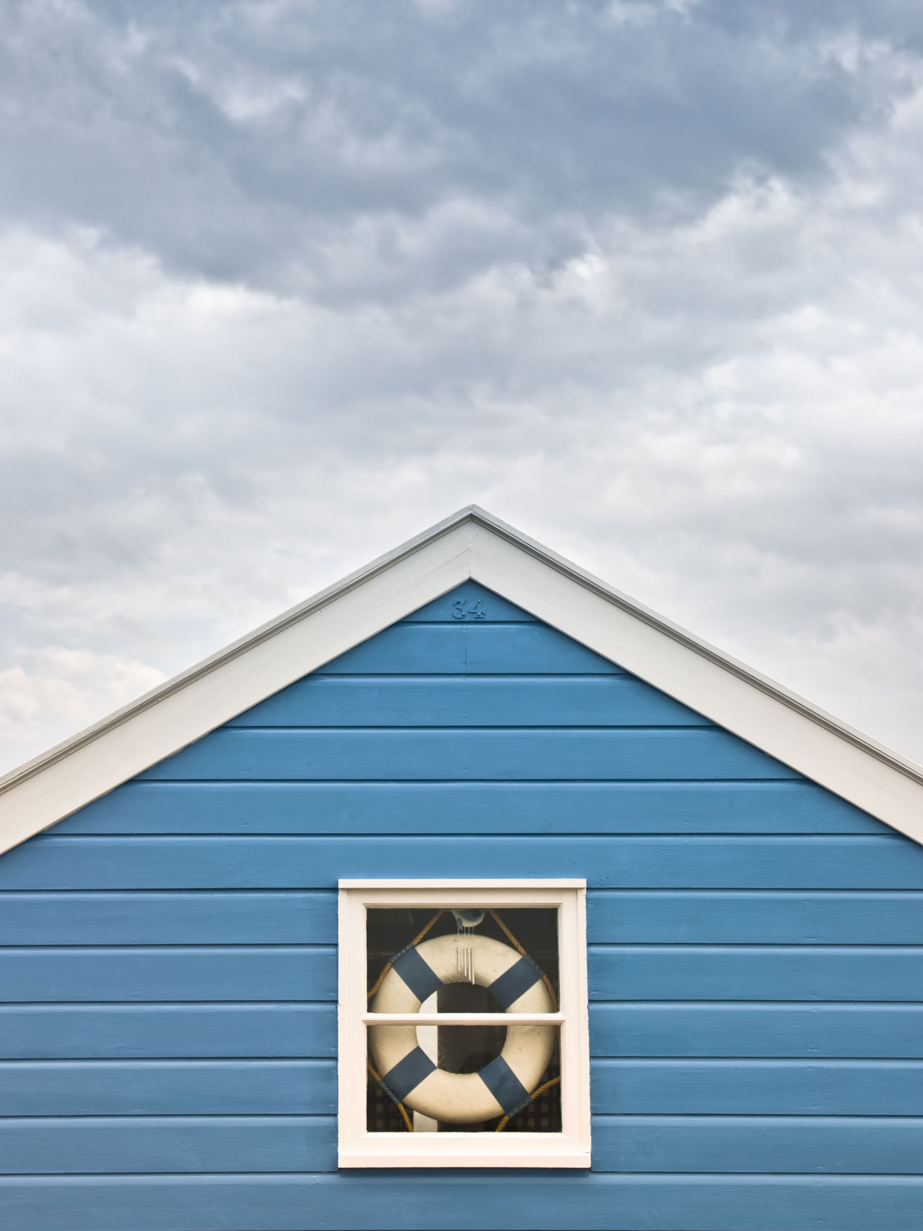 Breezy coastal mood fills a living room with the Blue Beach Hut wall mural