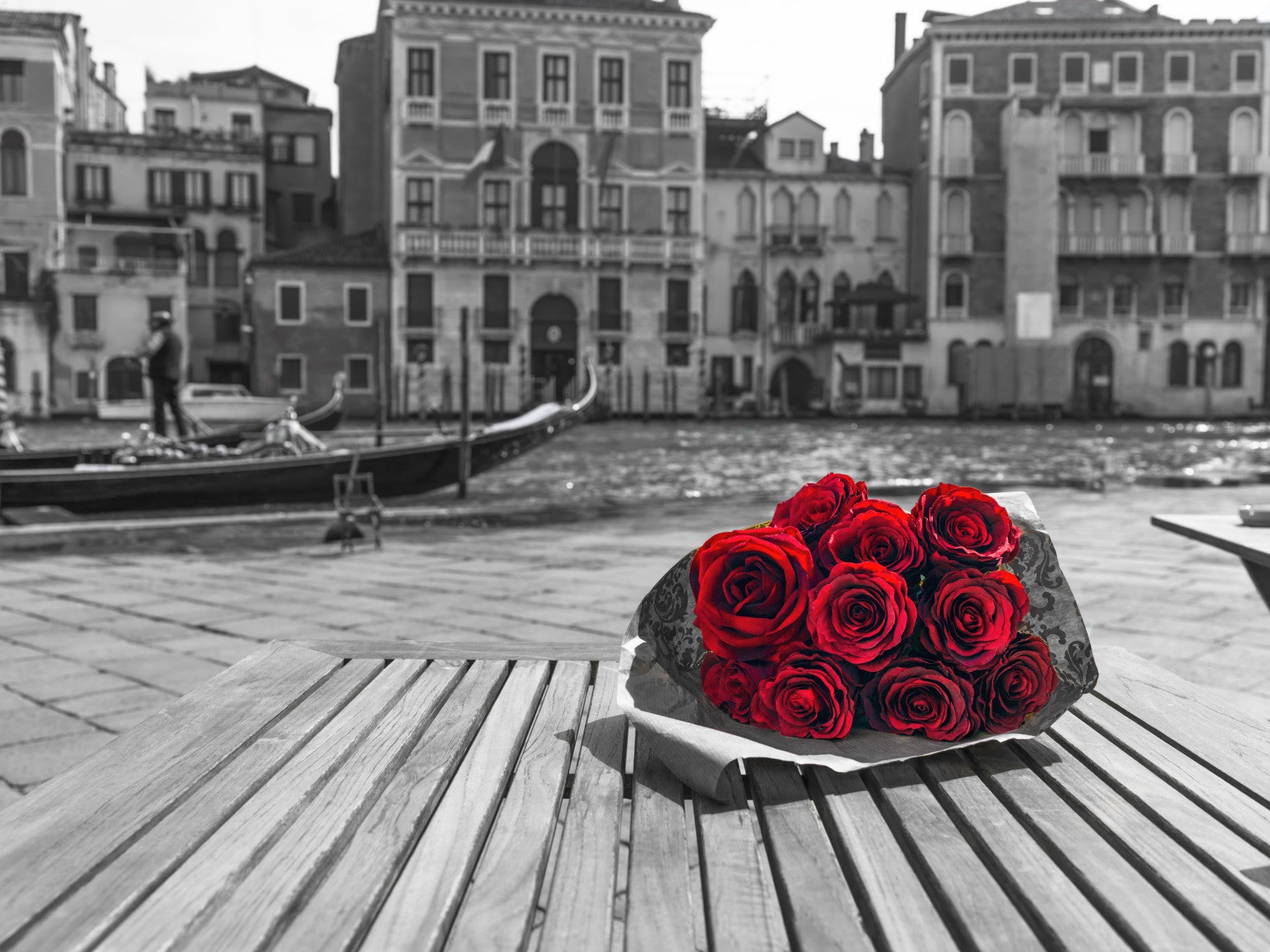 Stark crimson blooms front a living room in the Red Roses, Grey Venice wall mural.