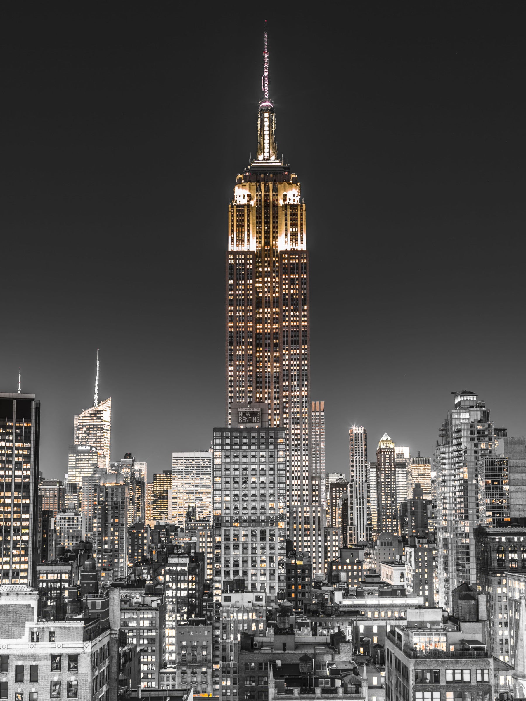 A dining room features the Empire Glow NYC Night in Grayscale Gold wall mural.