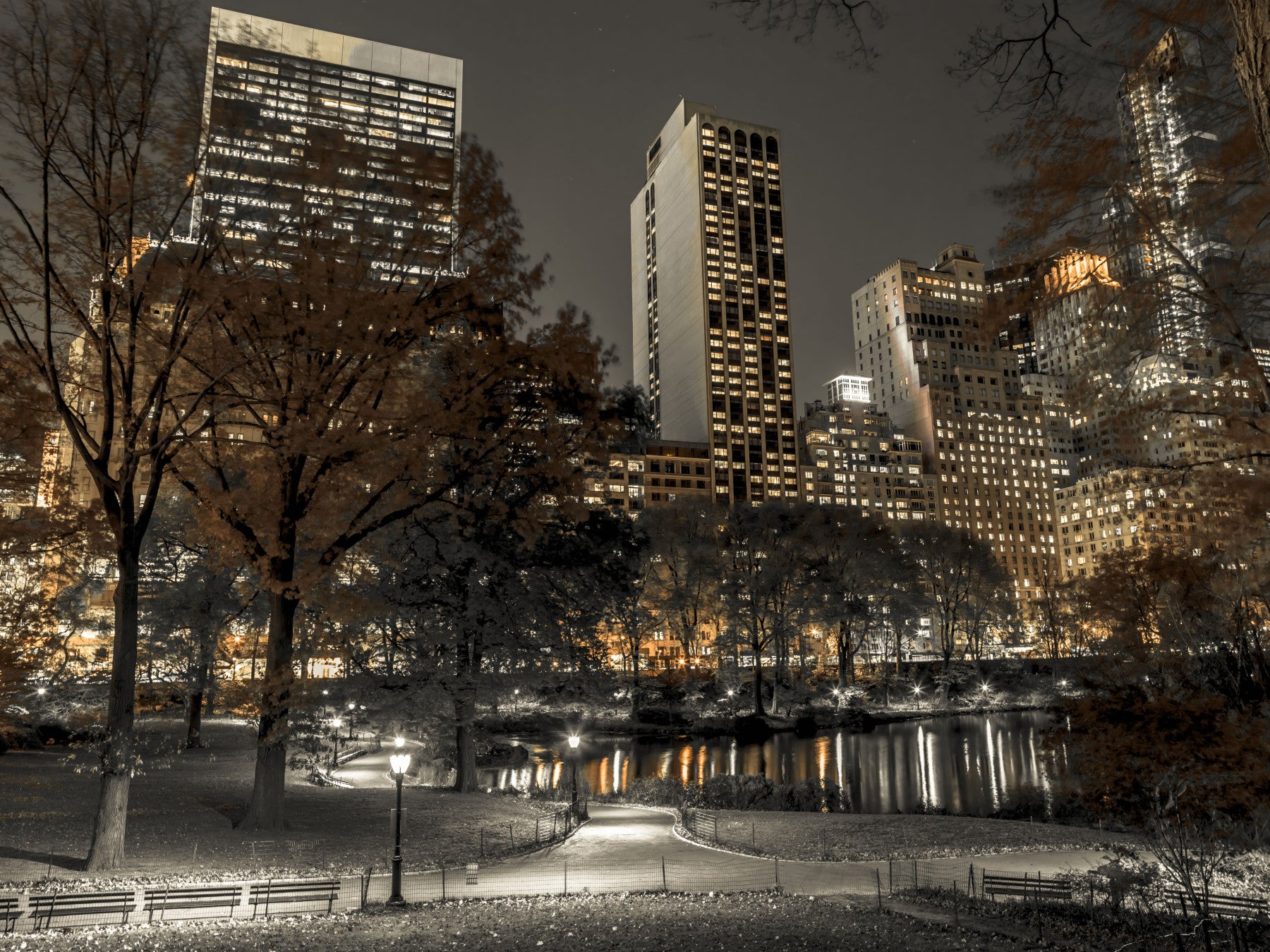 Sepia skyline drifts behind seating zones in the Urban Oasis Nights wall mural for a living room