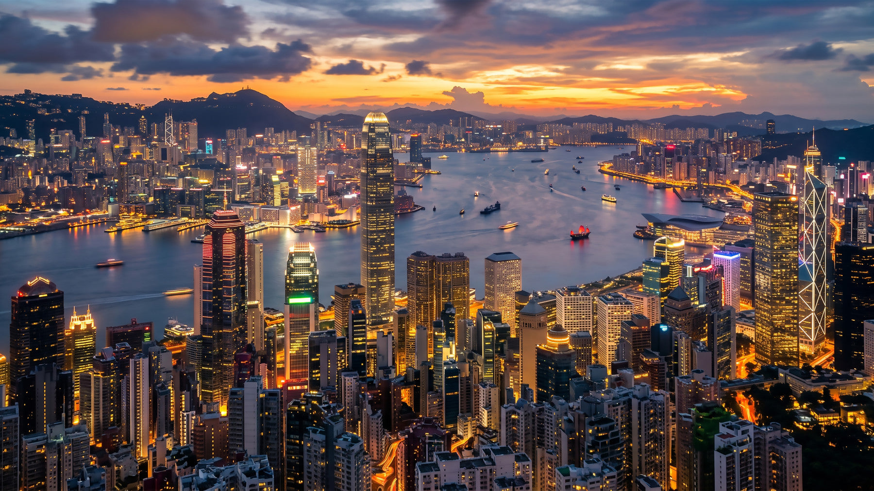 Minimalist bathroom fixtures sit beneath the vibrant Hong Kong Twilight Skyline Wall Mural.
