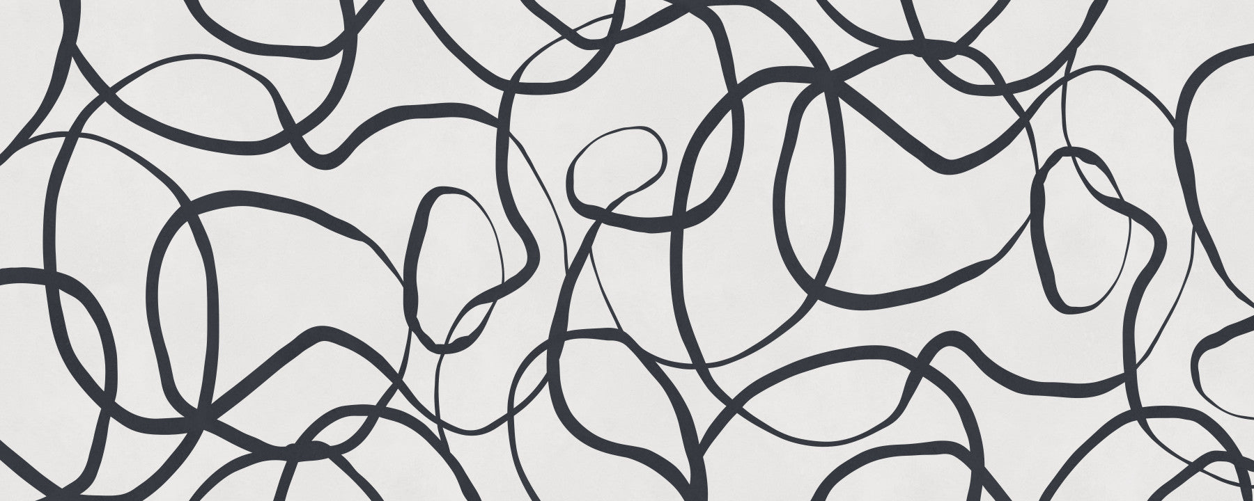Black loop curves drift across an Abstract Serpentine Lines wall mural in a living room