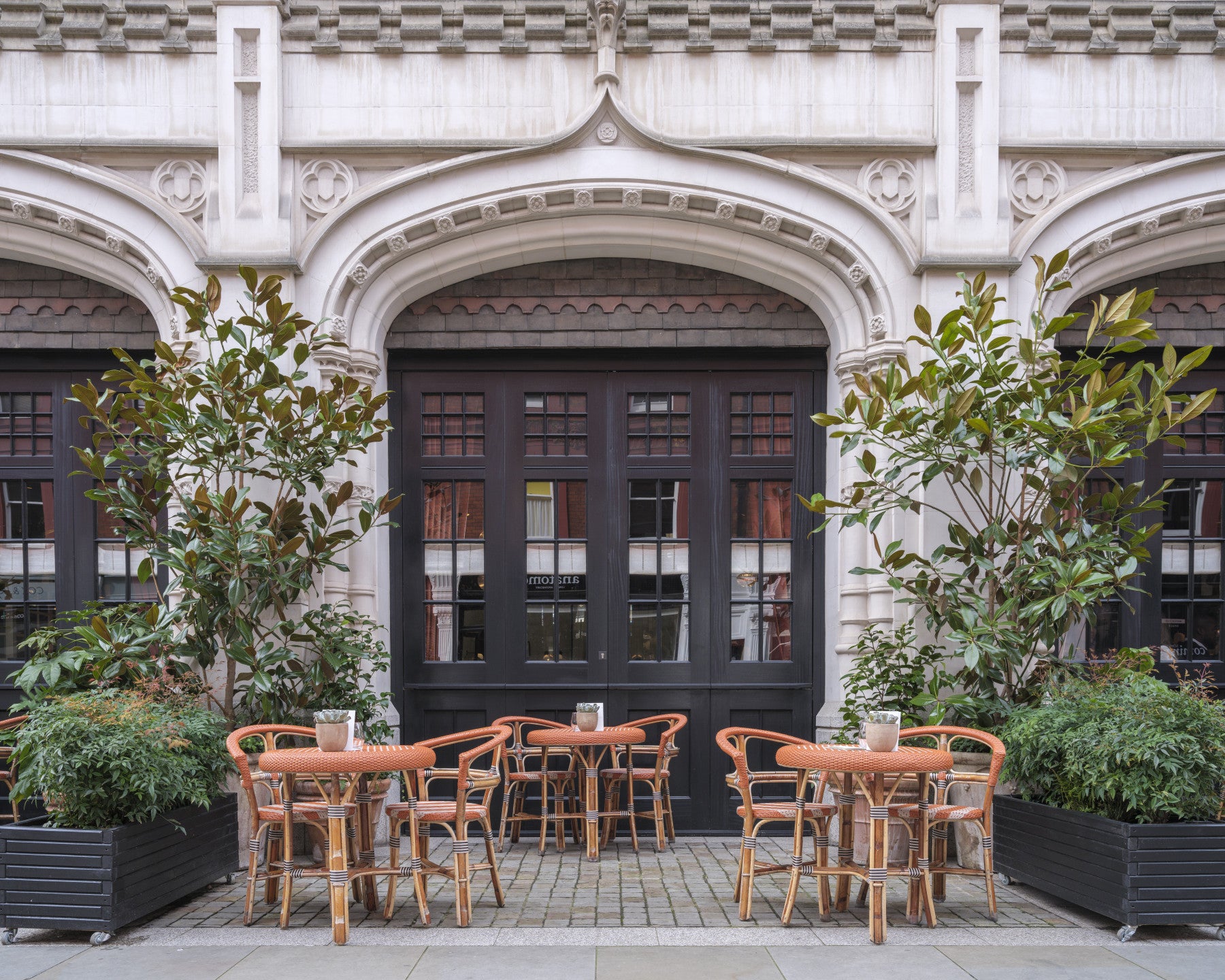 Street cafe wall mural with outdoor seating and cobbled lane